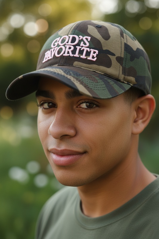 Camouflage baseball cap with 'GOD'S FAVORITE' in pink on a light gray background