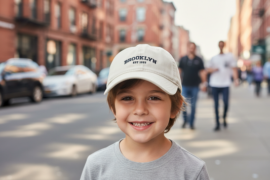 Beige cap with 'Brooklyn EST 1665' text on a beige background