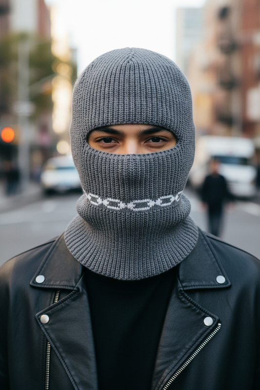 Gray knit balaclava with a black face opening on a white background