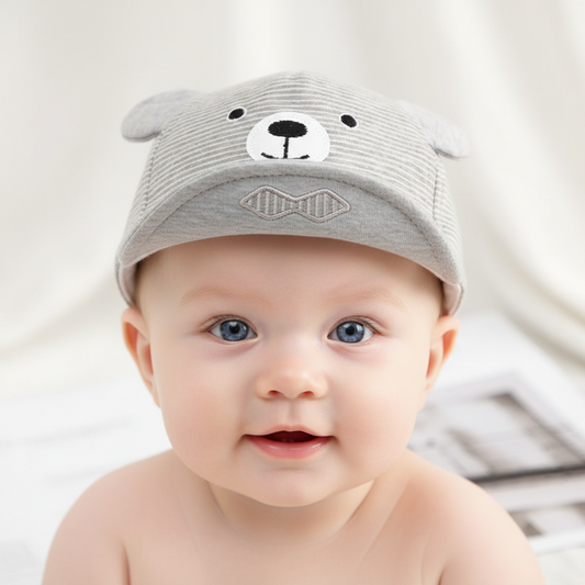 Gray teddy bear hat with a red label on a newspaper background