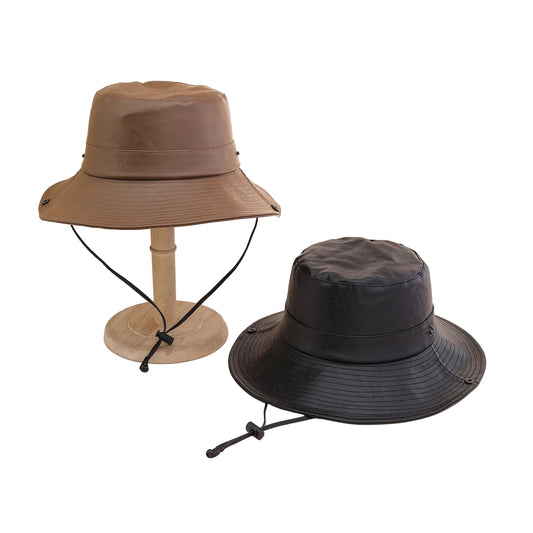 Two bucket hats, one beige and one black, on a neutral background.