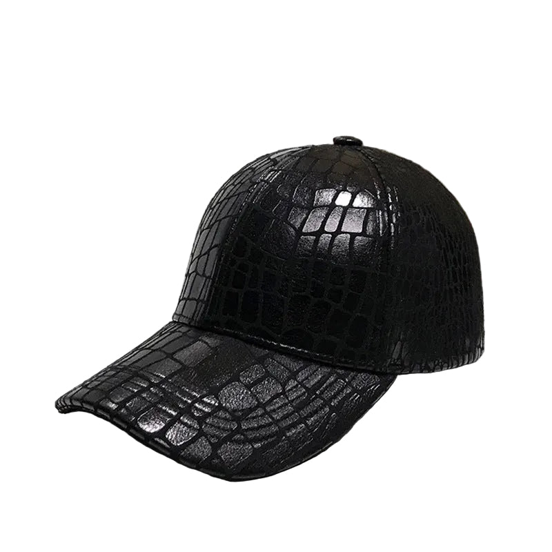 Black crocodile-patterned leather cap on a reflective surface with a blurred background