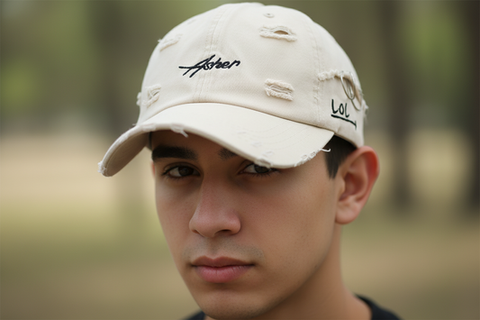 Beige distressed baseball cap with embroidered text on a white background