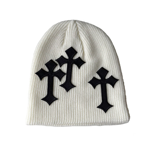 White beanie with black crosses on a gray background