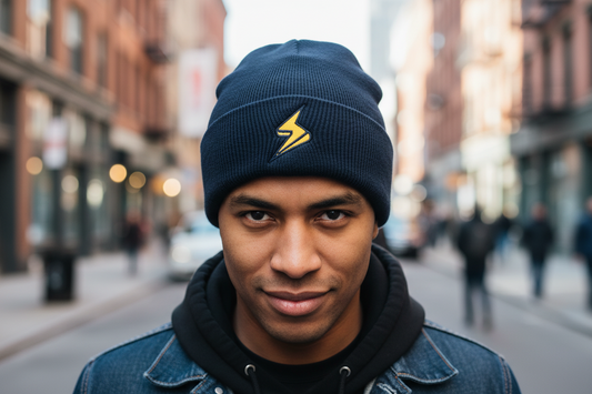 A knitted beanie with a lightning bolt embroidery on the cuff, featuring a black body with a pink cuff and a yellow lightning bolt design.