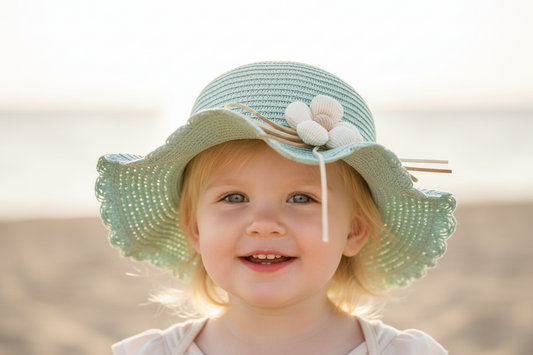 Light blue straw hat with a flower and ribbon on a white background